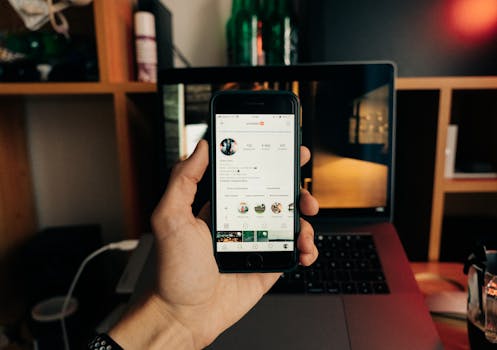 Close-up of a hand holding a smartphone with Instagram open, showcasing technology in use.