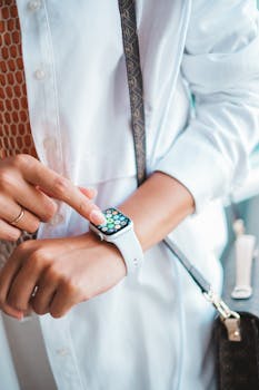 Close-up of a person's hand interacting with a smartwatch, highlighting technology and modern lifestyle.